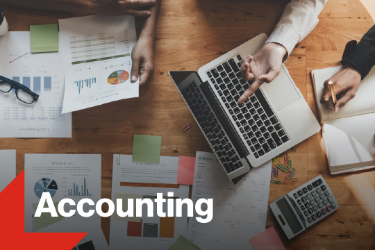 Photo of computer and charts with accounting text