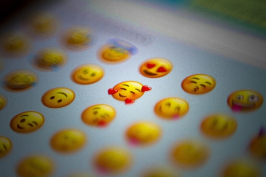 a list classic yellow emoji faces appear on a phone screen