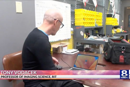 Tony Vodacek is shown at his desk analyzing the sounds animals make on a computer.