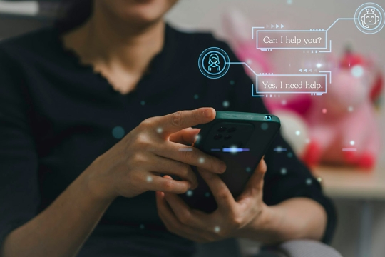 a person is shown holding a phone and a text overlay shows the phone prompting helpful words.