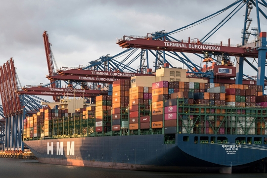a large cargo ship waits at port.