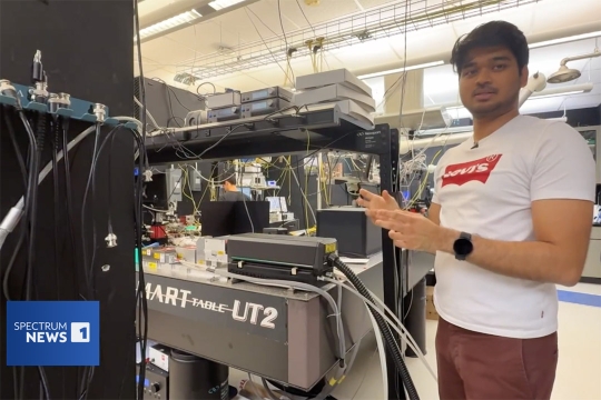 Man explaining lab equipment in a research lab with wires and electronic devices on a SMART Table UT2.