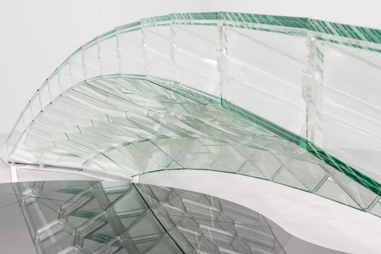 an architectural piece of glass bends around itself.