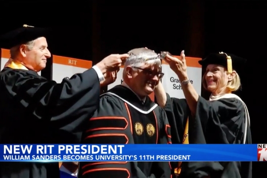 Decorative regalia is placed on Bill Sanders during his inauguration.