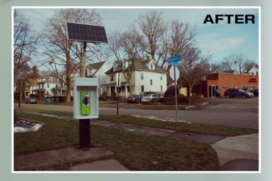 A photo that shows one of the newly installed Good Phones on the corner of Rutgers Street and Monroe Avenue. The photo aesthetic looks older like it was taken on a film camera. In the top right corner the word After is written, noting that this is what the location looks like after the phone was installed.