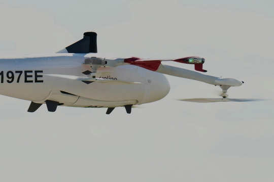 "two small windowless aircraft in the air 