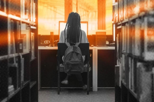 A photo illustration of a student working at a laptop in a library with a orange glow from the screen surrounding the student.