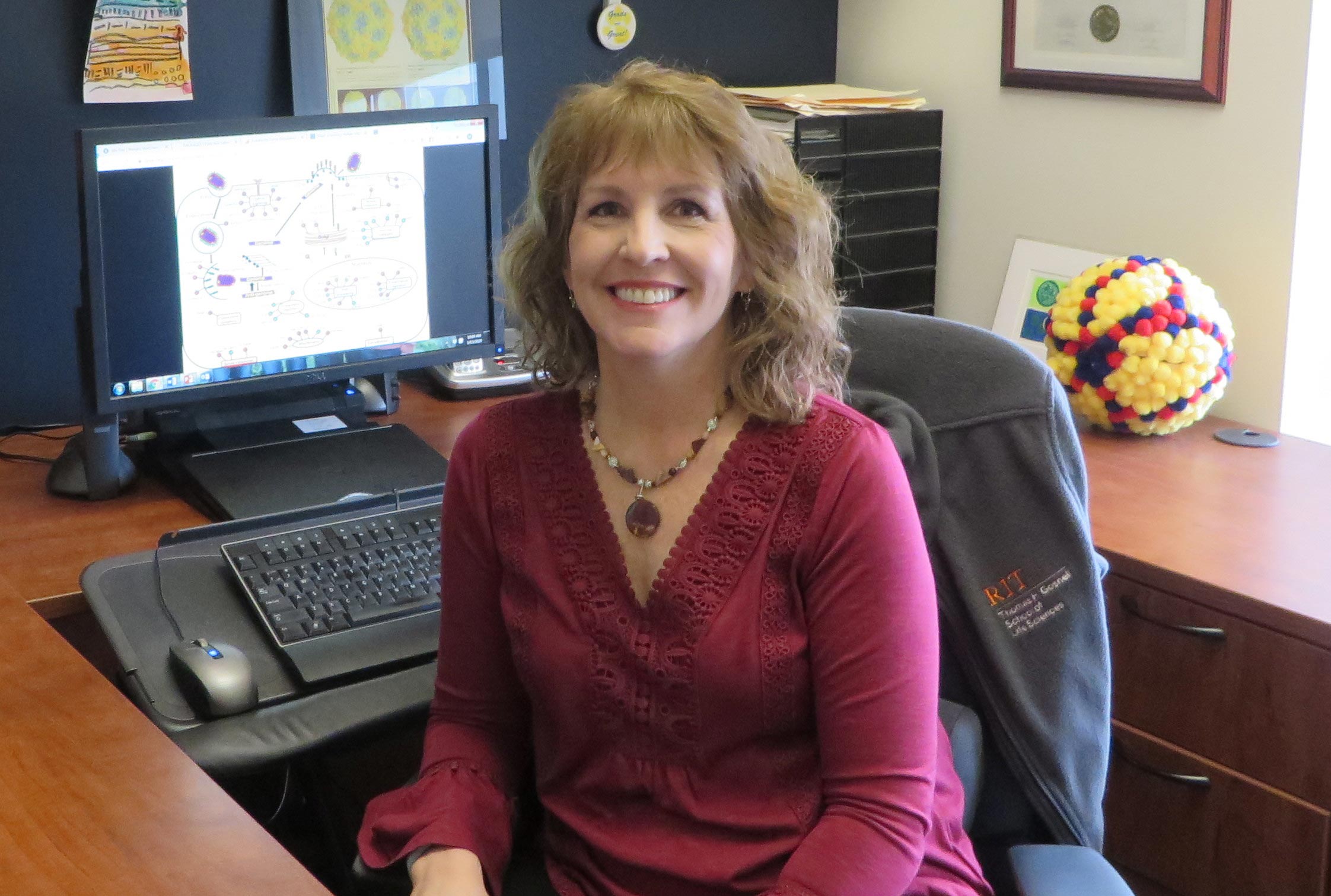 portrait of Maureen Ferran sitting at her desk.