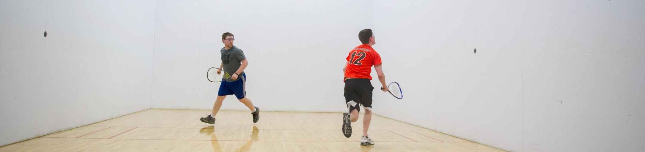 Two people playing racquetball.