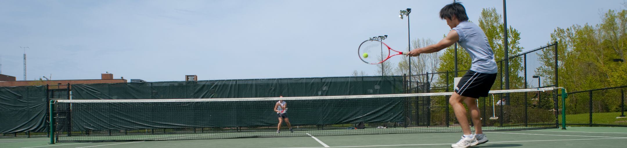 Two people playing tennis.