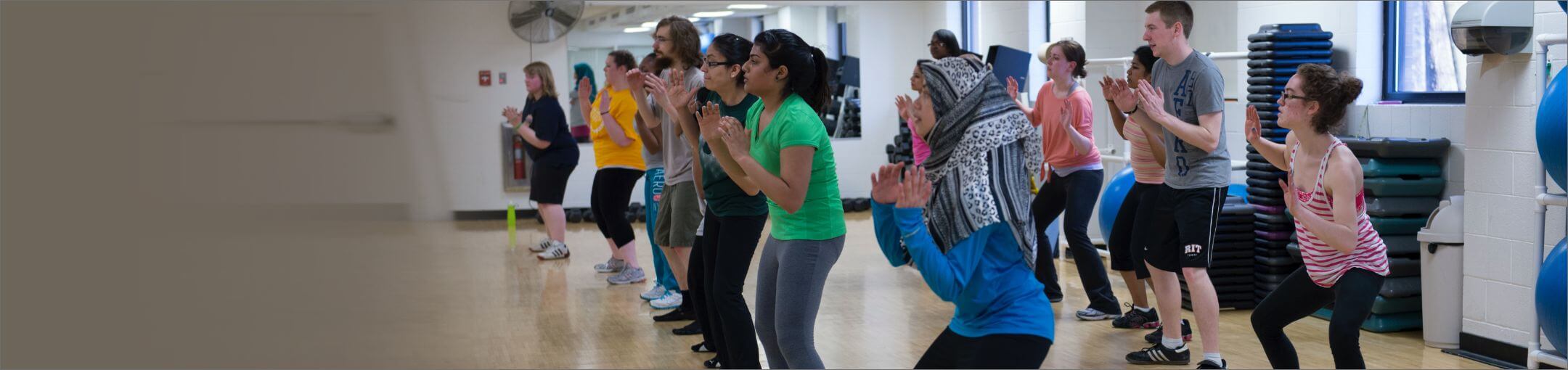 Students taking a fitness class in a studio.