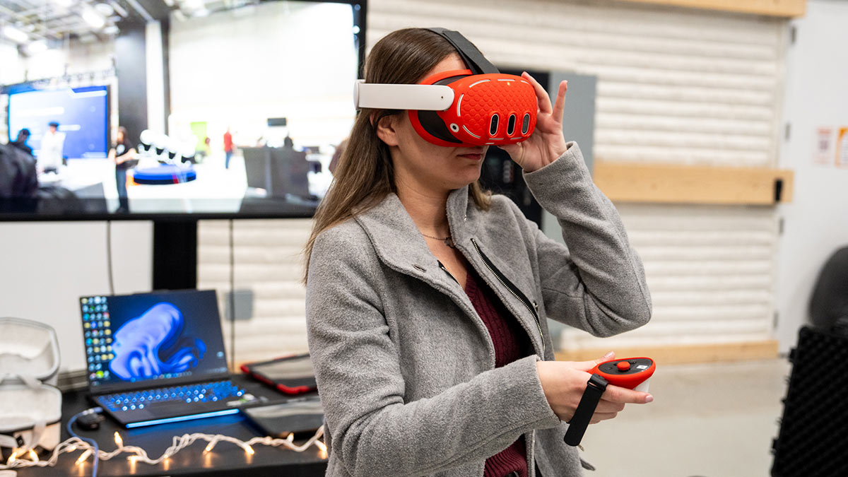 woman using a virtual reality headset and handhelds.