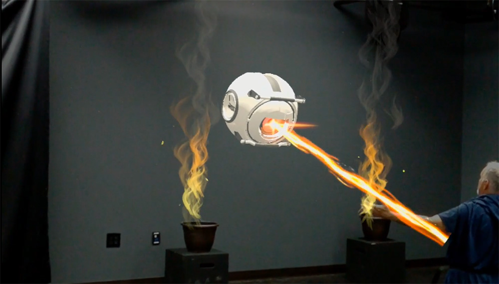 A robot shooting a laser at a person in mixed reality.