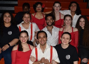 A group photo of members of the Latin Rhythm Dance Club all wearing red, black, and white.