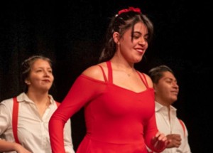 Three of members of the Latin Rhythm Dance Club wearing red and white.