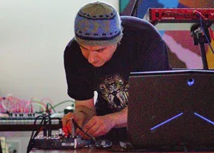 Performer with laptop and various cable inputs.
