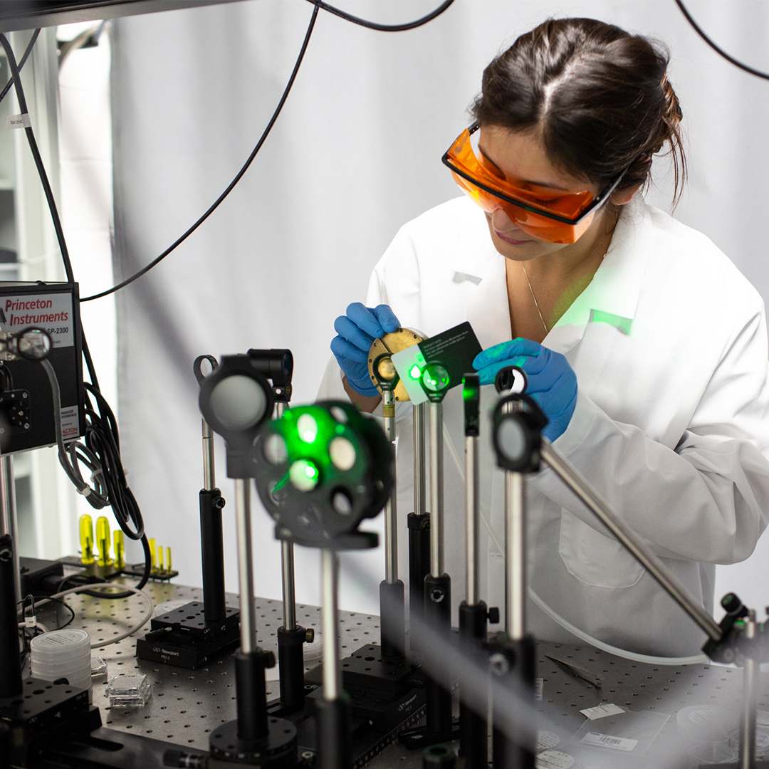 Female researcher working with lasers