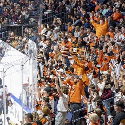 Students holding Brick City T-shirts