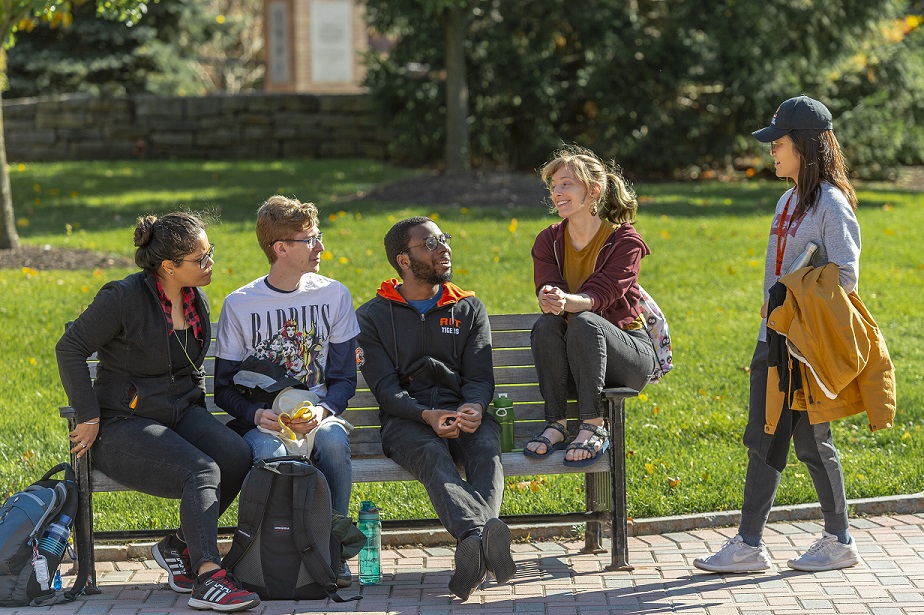 people sitting on the bench together to form an image