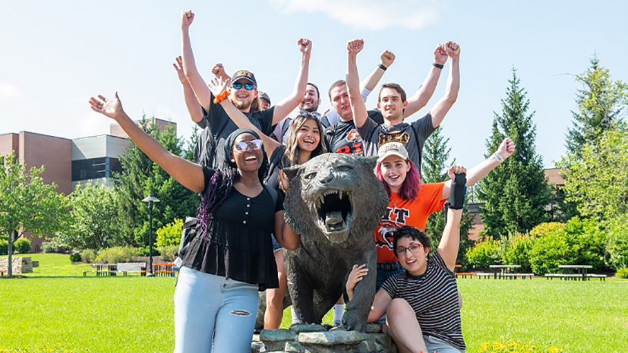 A group of students with RIT's mascot