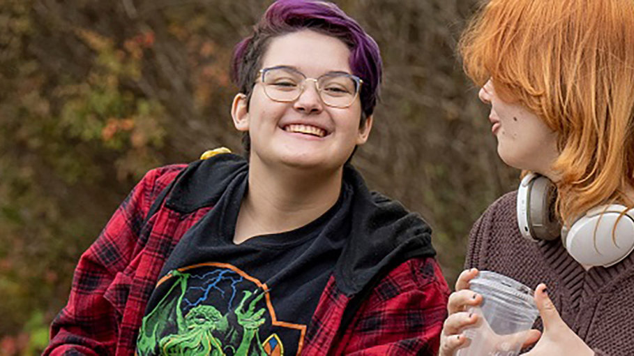 Students sitting outside, enjoying the weather.