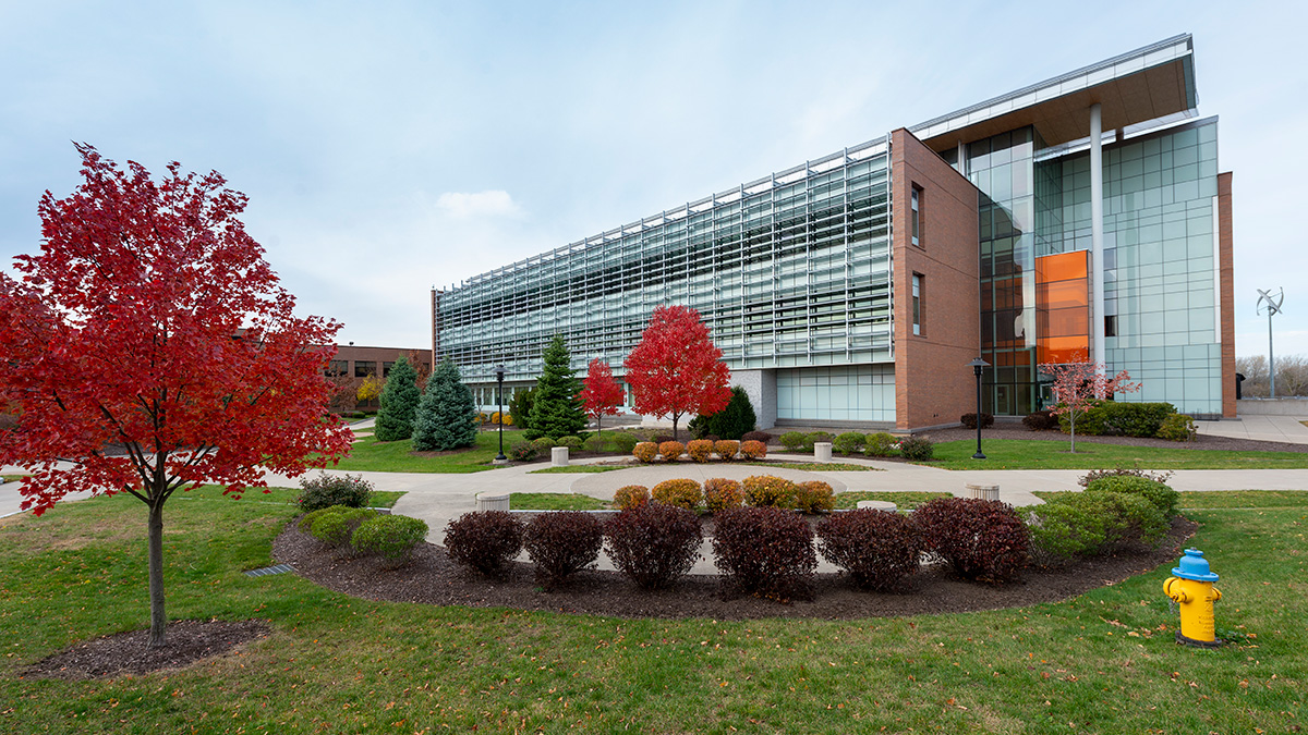 Outside of a building with trees changing colors in the fall.