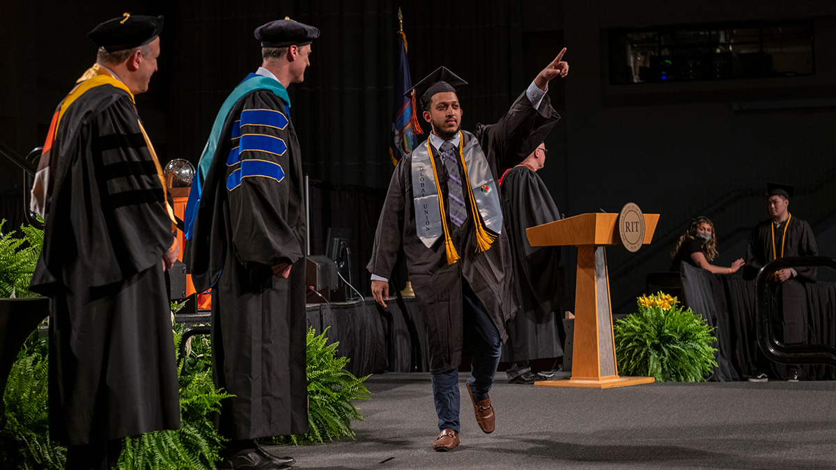 People at graduation, wearing caps and gowns.