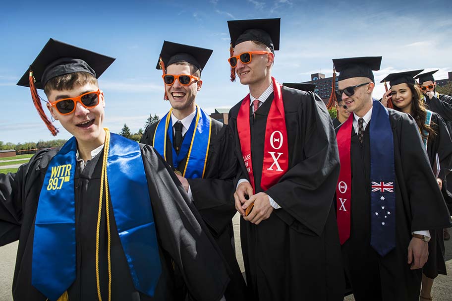 A line of students wearing caps and gowns.