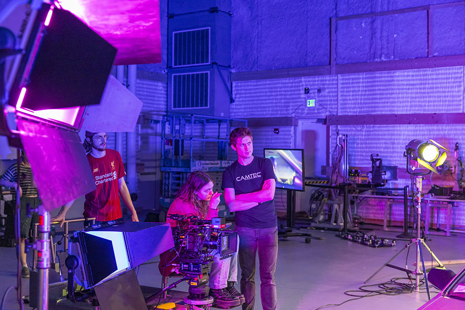 Students filming with stage lighting