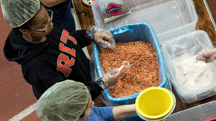 Volunteers for the Hunger Project packing food.