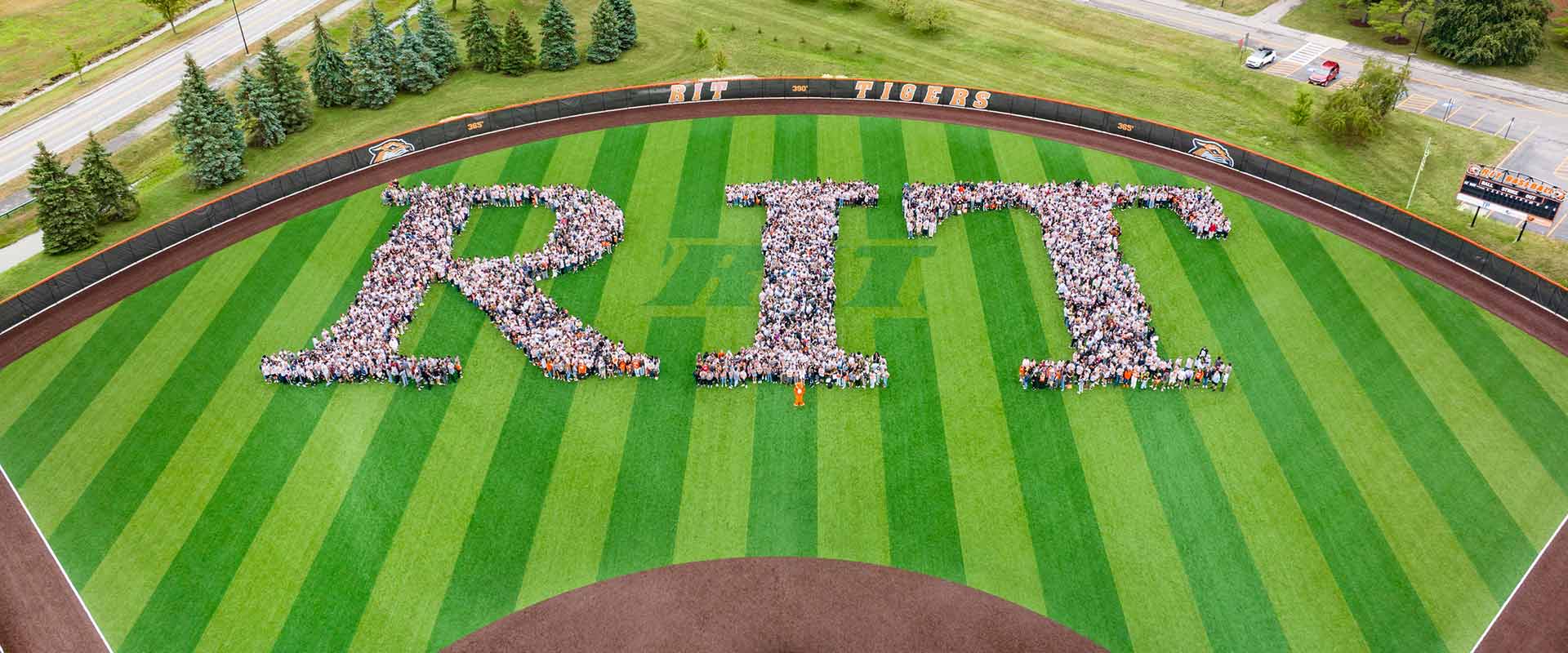 aerial view of the R I T baseball outfield, with the incoming freshman class arranged into the letters R I and T.