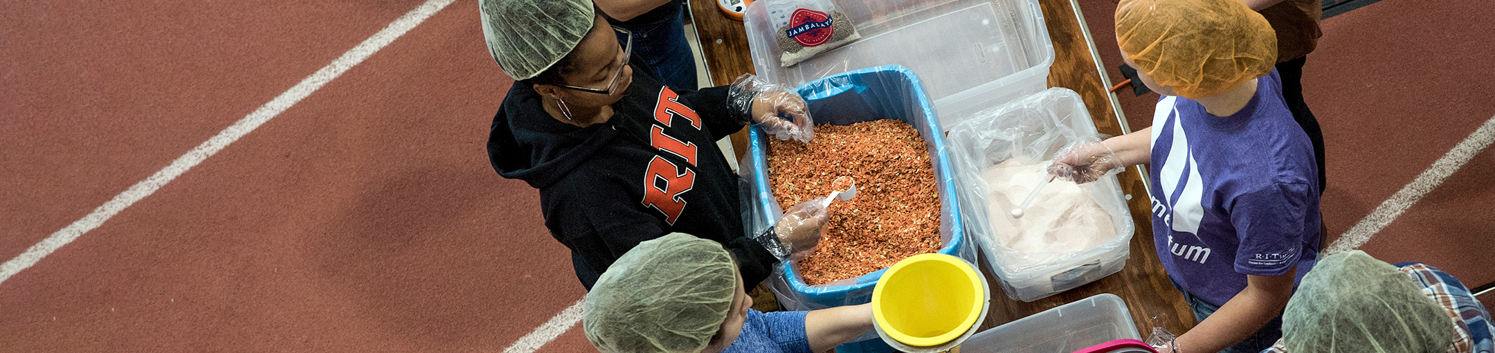 Volunteers for the Hunger Project packing food.