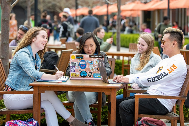 Students studying around a table outdoor