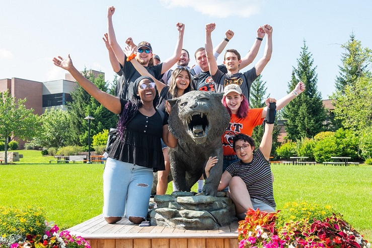 Students posing with the tiger statue.