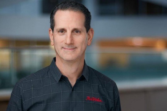 Head-and-shoulders view of man wearing blue True Value polo shirt.