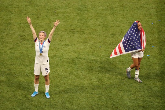 Two femle soccer players celebrate victory.