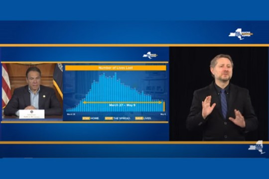 New York State governor giving update on coronavirus with ASL interpreter in an inset image.