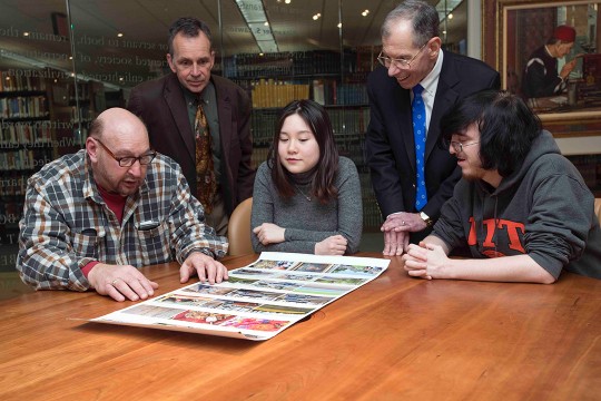 group looking at a glossy printout.