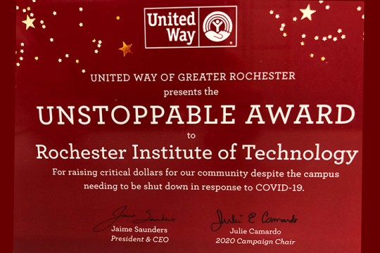 award that says: United Way of Greater Rochester presents the Unstoppable Award to Rochester Institute of Technology for raising critical dollars for our community despite the campus shutting down in response to COVID-19.