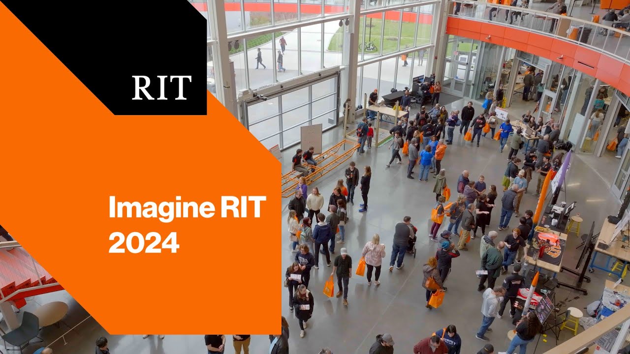 Crowd explores exhibits inside RIT building during Imagine RIT 2024; orange banner displays event name.