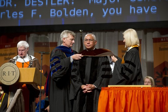 People fixing suit on stage