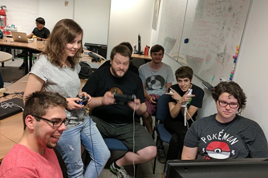 Team gathered around television