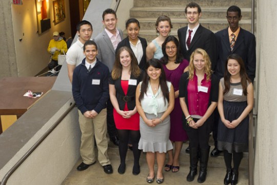 People posing in front of staircase