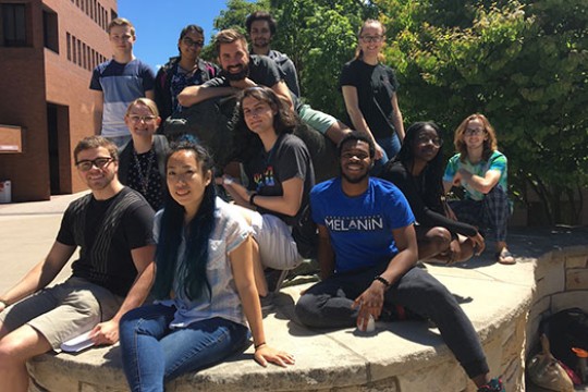 Group of students gather for a picture on campus.