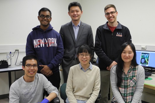 Team of five researchers poses.