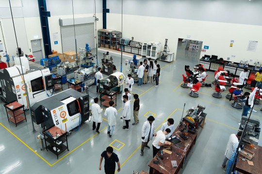 many people stand scattered in a computer engineering lab in Dubai