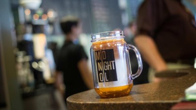 A midnight oil masonry glass mug sitting on a countertop