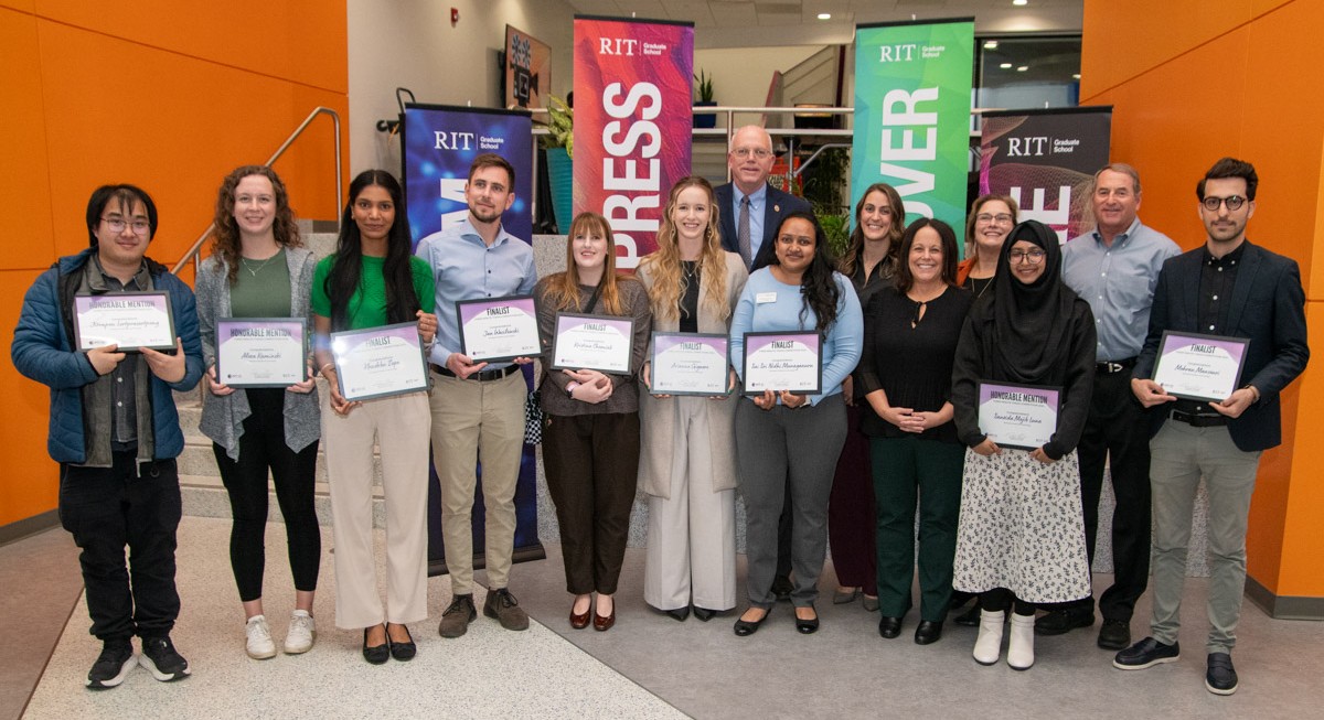 competitors pose with RIT president and judges during the 3MT competition