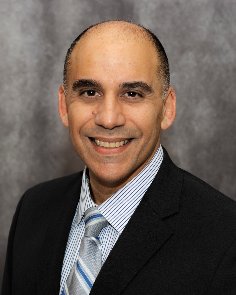 A professional headshot of Erich Hernandez-Baquero