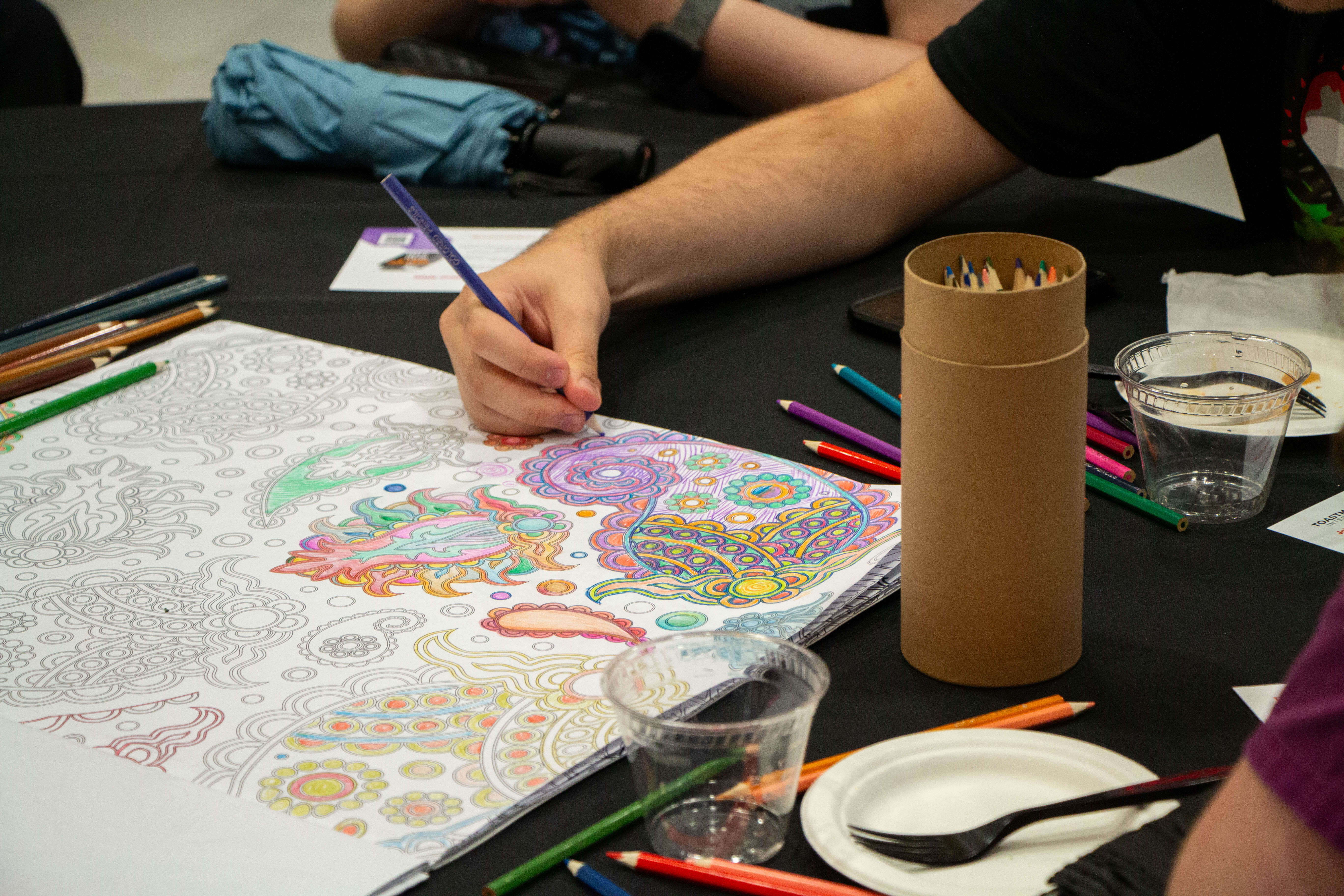 students color in the pattern on a big coloring book